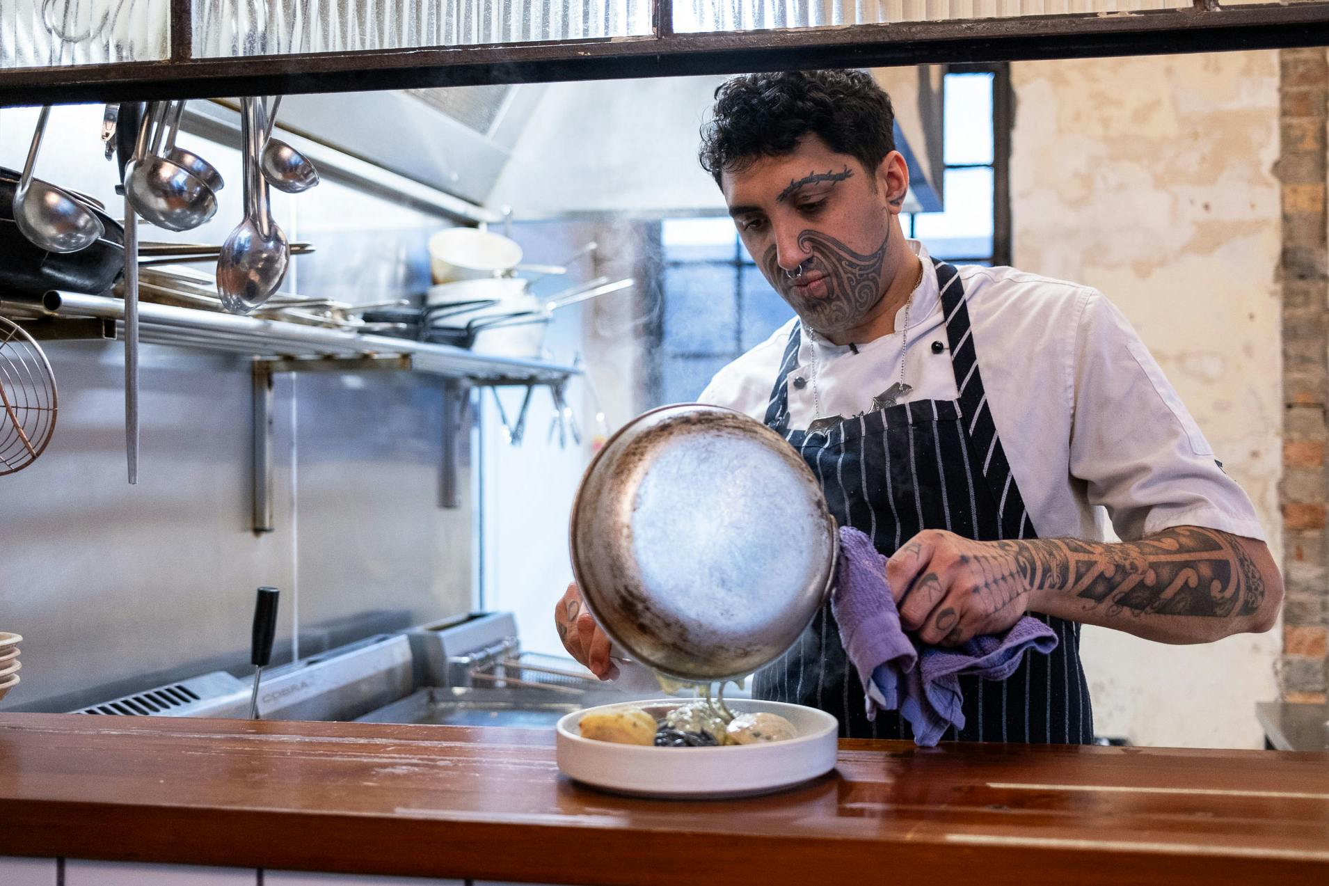 Kia Kanuta cooks a dish at Ada